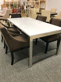 WHITE QUARTZ AND BRUSHED CHROME DINING TABLE BY MITCHELL GOLD. CHAIRS IN SUEDE SOLD SEPARATE