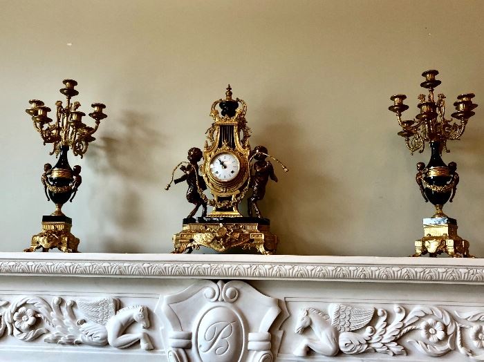 Bronze accented figural clock and matching urns