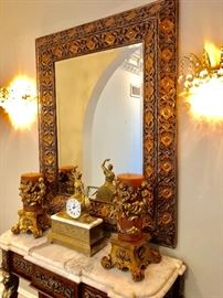 Ornate mirror above side table