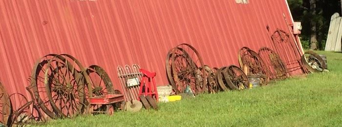 Closer Look at Some of the Wagon Wheels of Different Sizes and Types, Yard Art, Planters, Vintage Rusty Farm Equipment, Red Tractor Seat Stool, Iron Bed Headboards & More!
