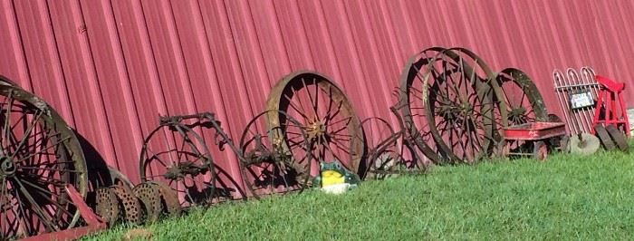 Closer Look at Some of the Wagon Wheels of Different Sizes and Types, Yard Art, Planters, Vintage Rusty Farm Equipment, Red Tractor Seat Stool & More!
