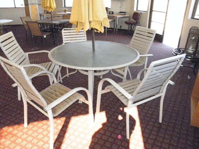 52 inch aluminum / glass top patio table and 5 commercial stacking chairs *******$75********* Call now for appointment...(760) 788-0775   ...(760) 445-8571