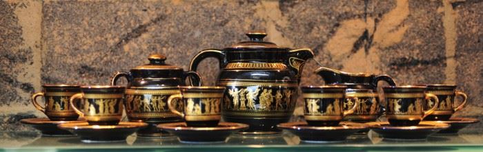 14 carat gold Greek motif over black tea set; includes 6 cups, cream & sugar servers, tea pot.