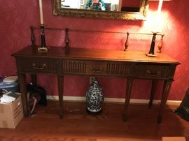 #24 Century entry table with 3 drawers and metal bar back 67x17x32 $225.00