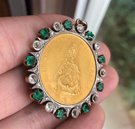 22k Gold Pope’s medal surrounded by 14k gold bezel with 9 diamonds, 18 diamond chips and 9 emeralds. 