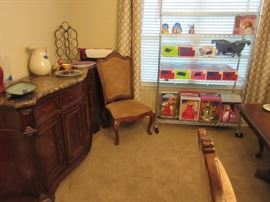 American Dools , Barbies, and dinign room credenza.