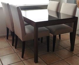 Crate and Barrel Parsons dining table 60x36". Black glass on Elm base. Upholstered dining chairs. Purchased about 2 years ago.