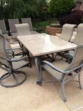 Granite topped outdoor table with 2 arm chairs and 6 swivel rocker chairs