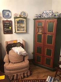 painted wood cabinet, upholstered chair and ottoman