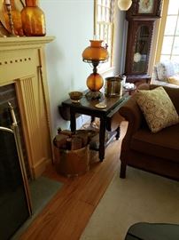 Side tables in dark pine with Amber glass hobnail lamps and brass accessories. 
