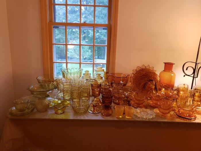 Amber colored crystal plates, cups, glasses,  decanters, pitchers and bowls.