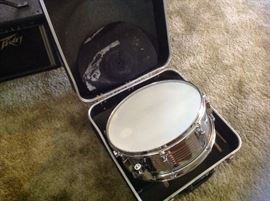 Metal snare drum with case, sticks, and practice pad