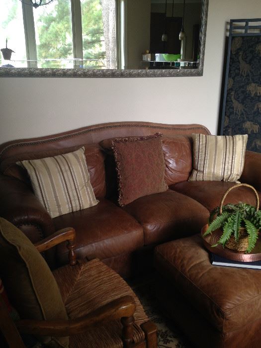 Large leather ottoman serves as a great coffee table