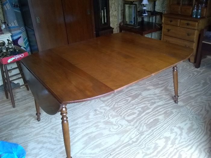 Vintage dining table. Has two extension leafs and fold down ends. 