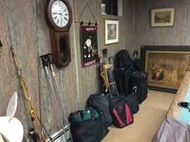 luggage, fishing poles, sleeping bag, inflatable mattress, clock 