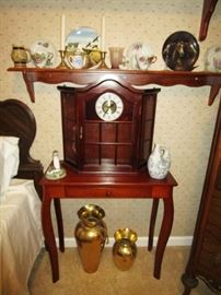 Wooden table, wall clock/display cabinet, cups & saucers, 2 matching twin beds, brass vases, Misc. decor