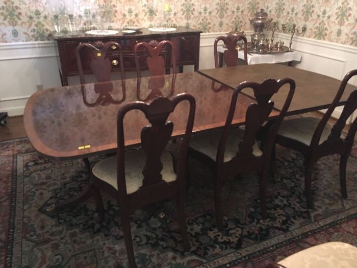 Elegant Duncan Phyfe-style Dining Table with eight matching chairs (pair with arms). Table has double-pedestal base, 2 leaves and pads.