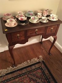 Baker Console Table with burled wood front and an excellent collection of tea cups on top.
