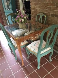 Lovely carved wood Table with a glass top and a set of 4 blue/green dining chairs