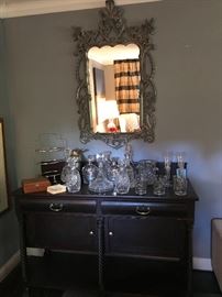 An American empire bar circa 1880 covered with crystal decanters and Crystal stuff aware behind a silver leaved mirror. That account is our Waterford and other.