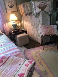 Teenage girl bedding and a Pottery Barn carpet.