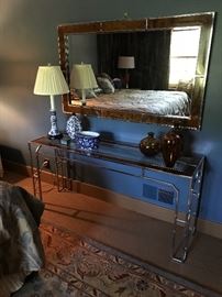 A side table and matching mirror in the style of Milo Baughman