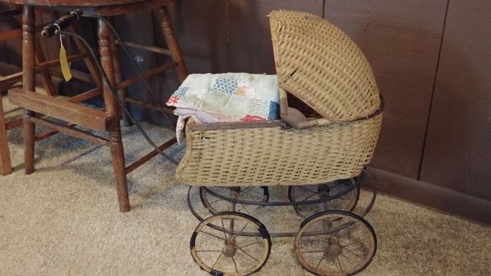 Antique baby buggy with bedding