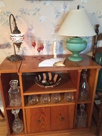Small Cabinet, unique stain glass lamp, Grecian Urn lamp, candlesticks, vase, decanters, wine glass, bowl