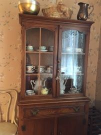 Hutch and glassware and teapots and teacups