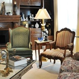 Notice the crystal floor lamp behind the antique marble top triangle table with 2 vintage country French chairs - a pair of Armani porcelain figurines are on the shelves in the background.