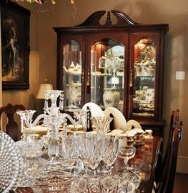 The dining table with leaves has 6 side chairs and 2 arm chairs.  Table top features a very fine glass 5 point candelabra and other fine pieces.