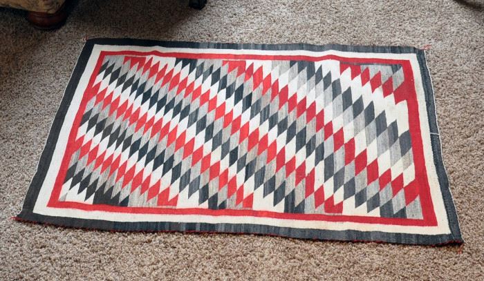 51" by 37" Navajo rug, late 1930s, probably from Ganado AZ, handspun natural sheep wool with red anline dye, serrated Diamond with banded borders.