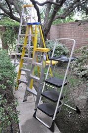 An assortment of ladders may be found on the walk off the patio.  The garage is overflowing...