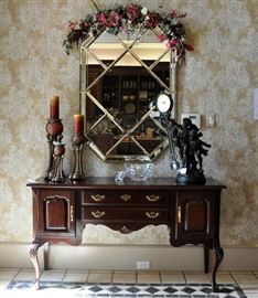 Thomasville entry sideboard, beveled mirror with brass banding, swinger clock