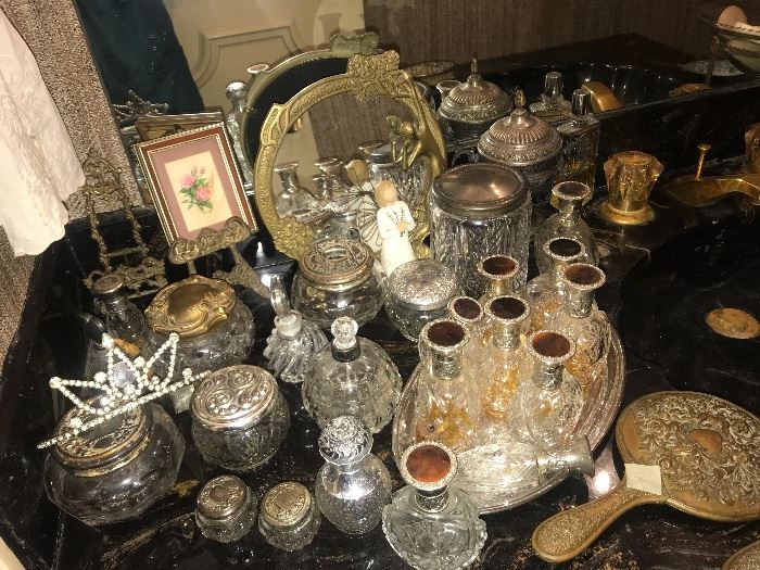collection of silver and crystal perfume bottles and powder jars
