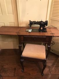 vintage Singer sewing machine in cabinet and stool