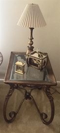 Metal accent table with glass top and various decor 