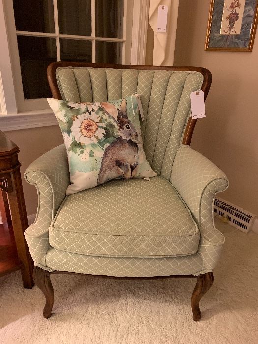 One of a pair of mint upholstered channel back chairs.