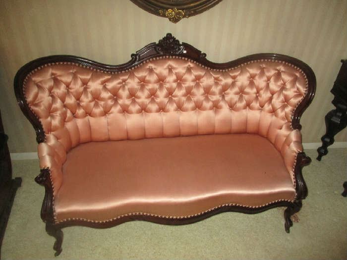 Antique Victorian parlor settee, tufted pink satin upholstery, mahogany frame, circa 1860