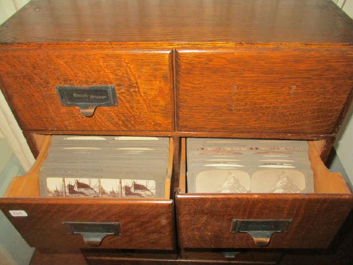 Oak Cabinet, all drawers are filled with stereoscope cards and the bottom drawer has 2 viewers