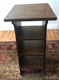 Mission oak side table above a 3-shelf book stand