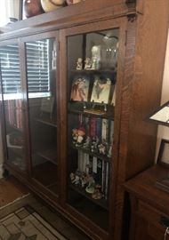 Large antique three-door bookcase with carved griffins