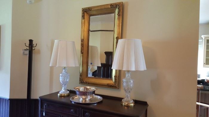 Sideboard with a pair of crystal lamps and gilded mirror