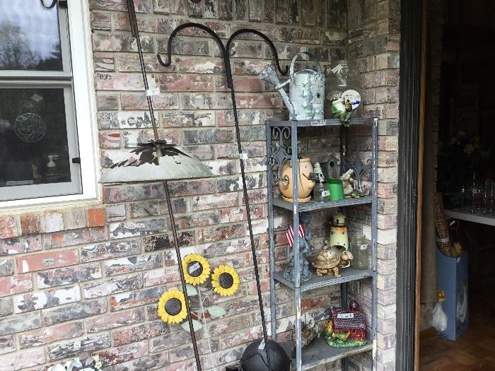 Patio - shepherd’s hook , metal shelf full of garden items