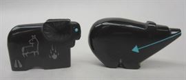 Southwest black onyx and obsidian carved Fetish figures: a bear with inlaid turquoise arrow and eyes., a ram with turquoise eyes and "cave" carvings on the side signed U.W. Largest is 1.25" tall