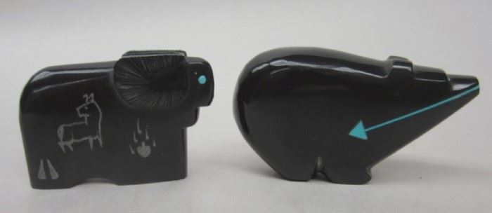 Southwest black onyx and obsidian carved Fetish figures: a bear with inlaid turquoise arrow and eyes., a ram with turquoise eyes and "cave" carvings on the side signed U.W. Largest is 1.25" tall