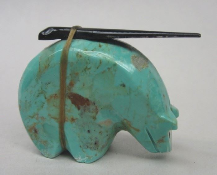 Southwest carved turquoise bear fetish figure. Has black spear tip tied to its' back with sinew. Attributed to Brenda Peterson. 1.75" long