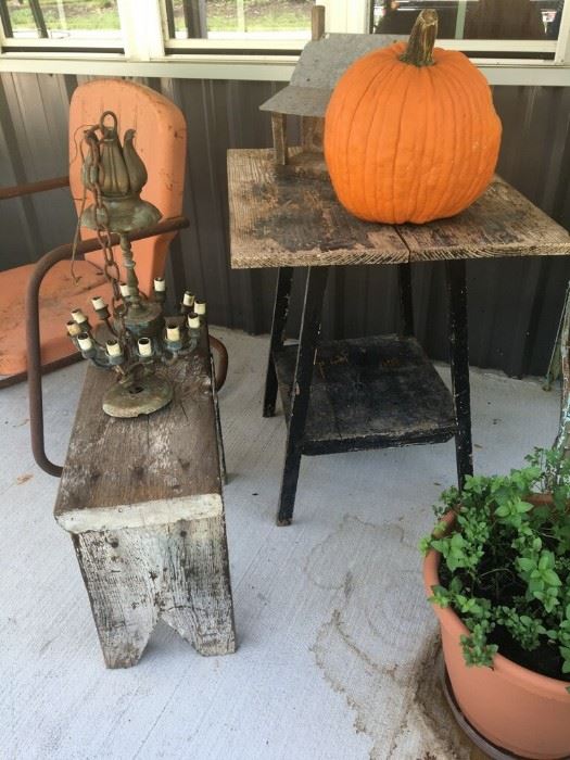 Vintage side table, wooden stool, and metal lawn chair.