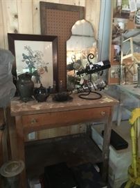 Vintage wood desk, framed peg board, mirror, floral picture, pewter pitcher, teapot, and creamer container.