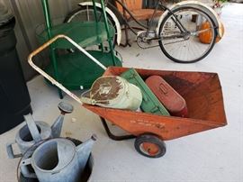 Vintage radio cart, metal tool boxes, and watering cans.